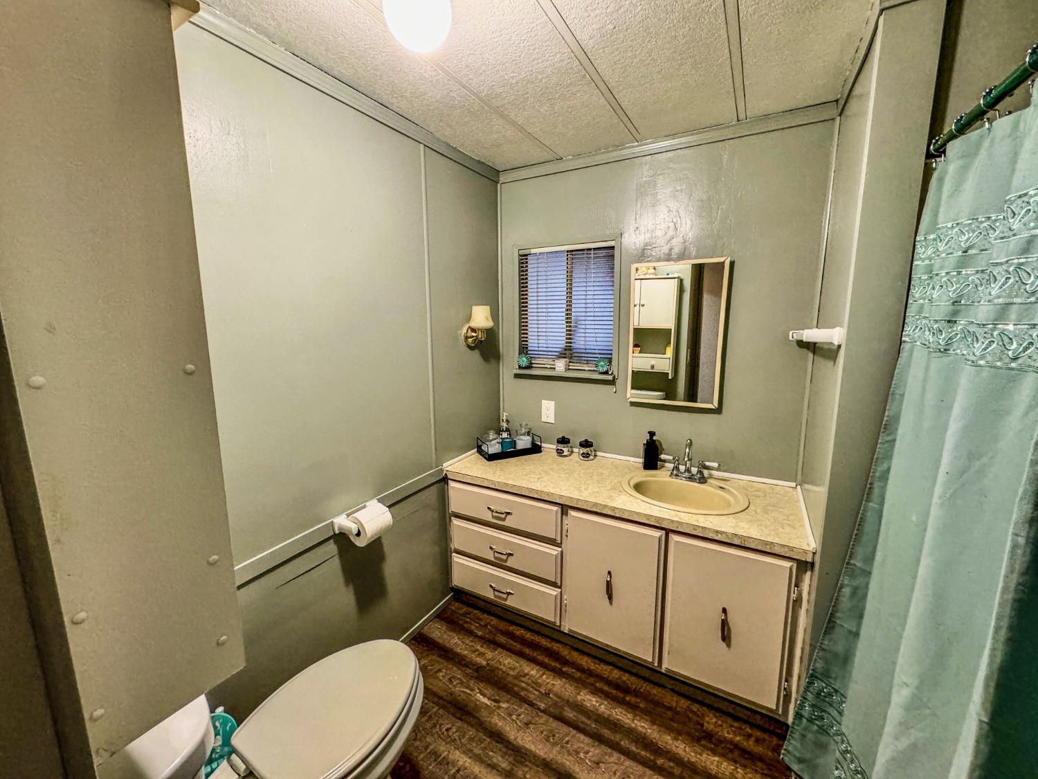 3950 Mack Road, Unit 182 Sacramento, CA 95823 - Photo 9 of 35 a bathroom with a toilet sink and mirror