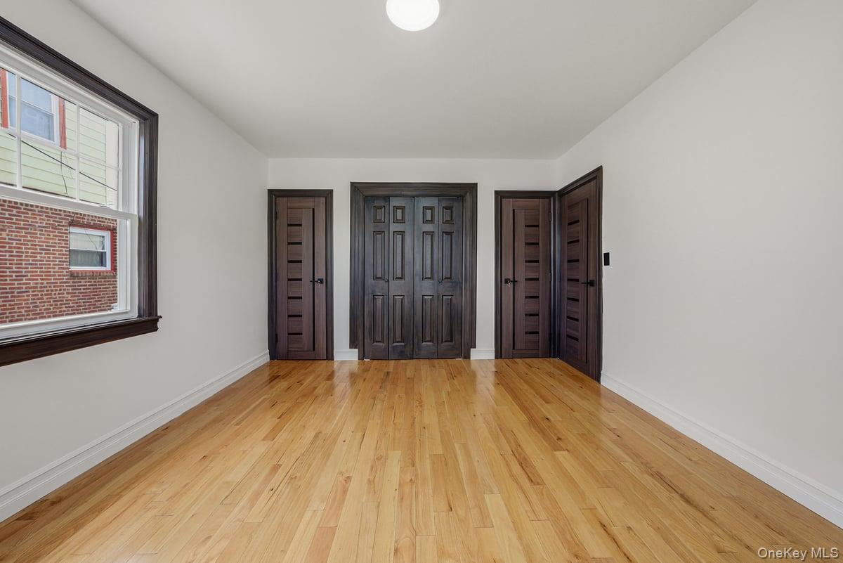 118-27 201st Street Queens, NY 11412 - Photo 11 of 36 a view of an empty room with closet and a window