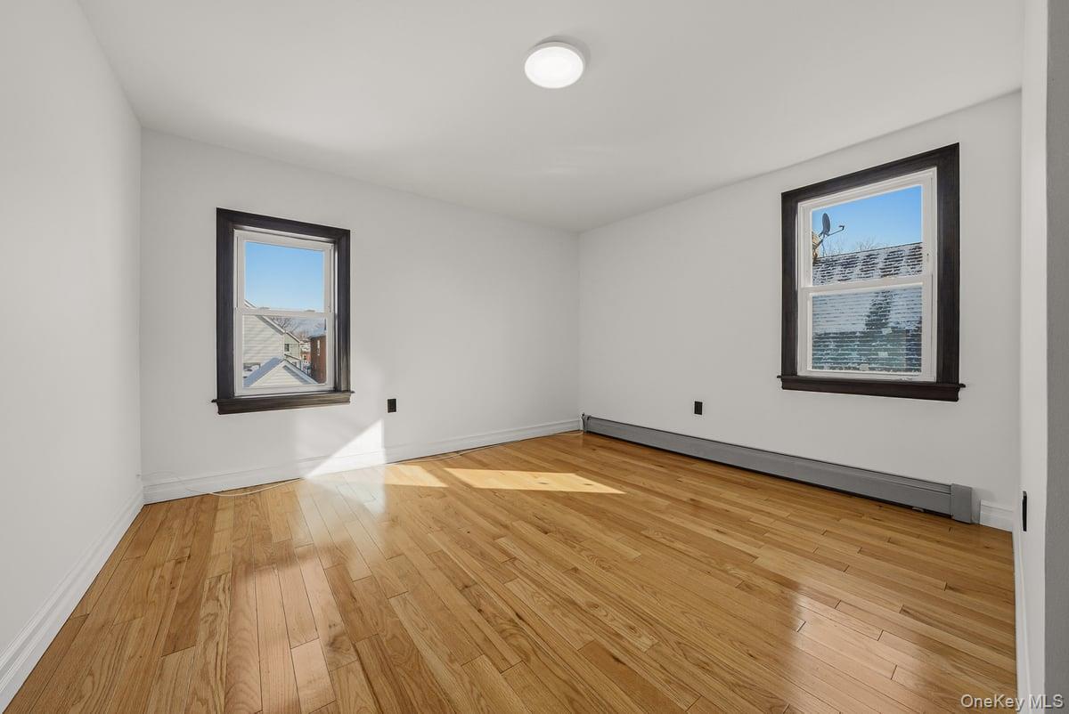 118-27 201st Street Queens, NY 11412 - Photo 20 of 36 a view of empty room with wooden floor and fan