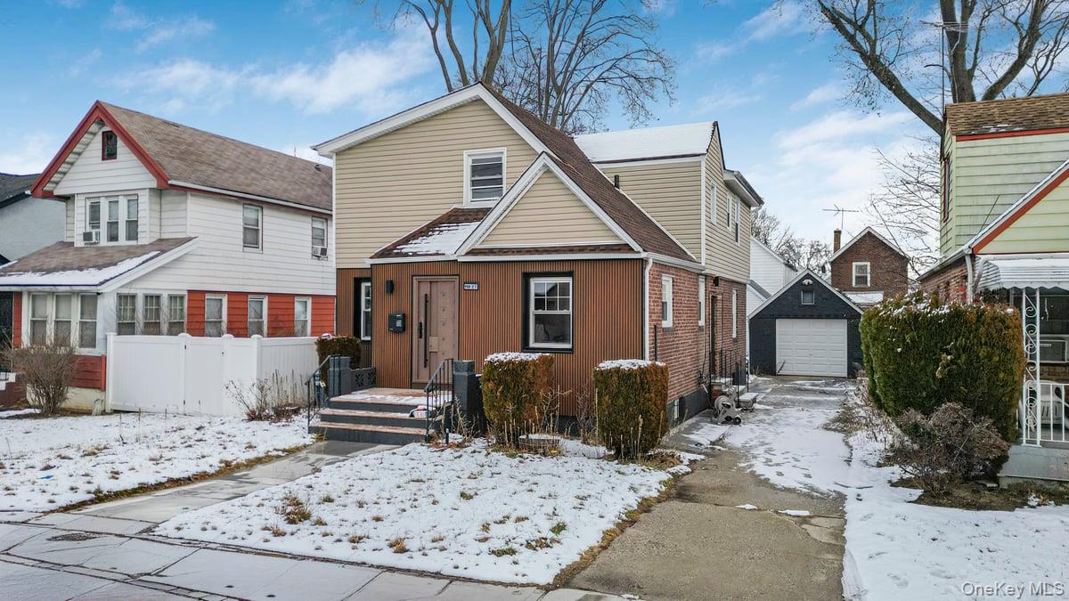 118-27 201st Street Queens, NY 11412 - Photo 2 of 36 a front view of a house with garden