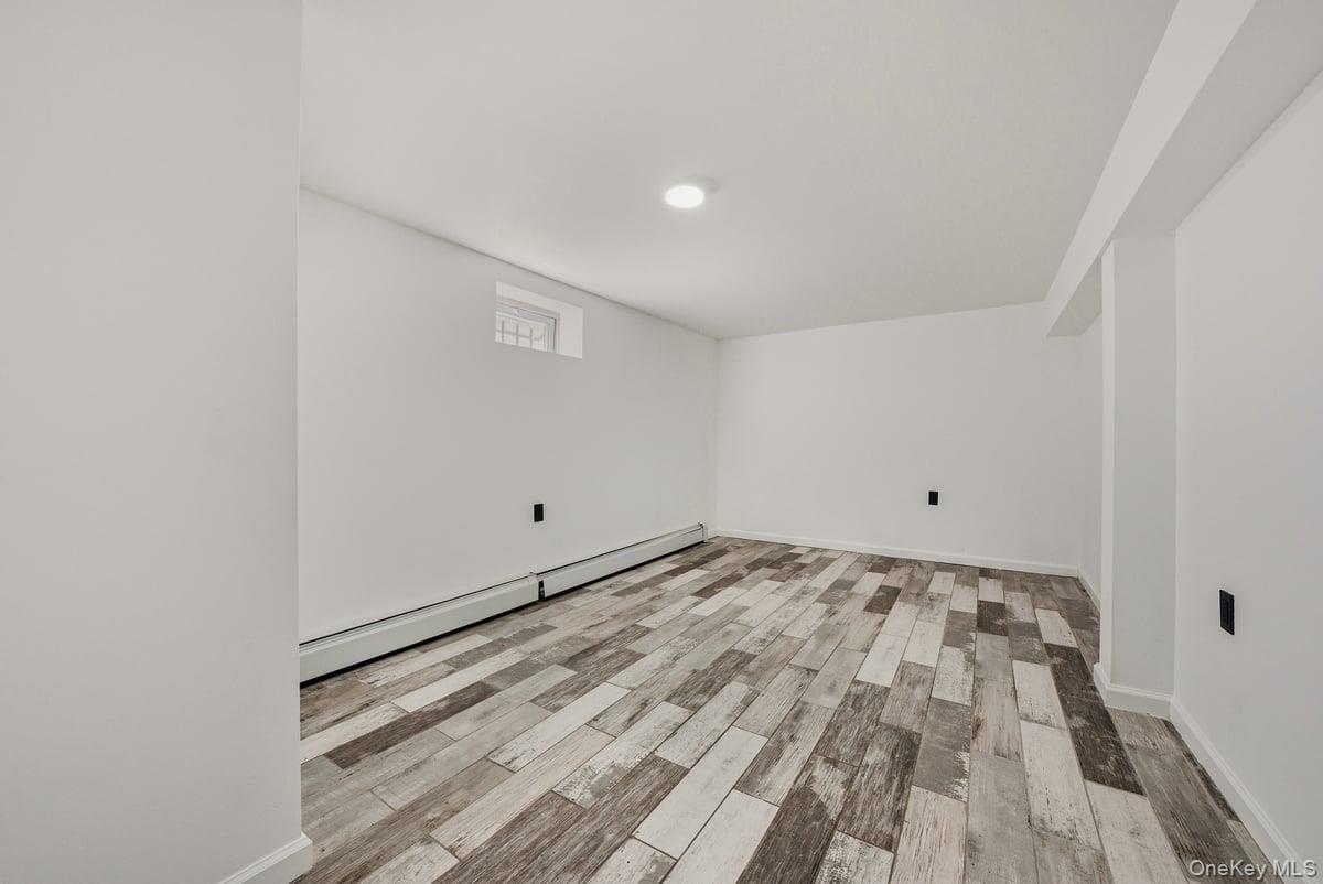 118-27 201st Street Queens, NY 11412 - Photo 29 of 36 a view of a room with wooden floor and bench