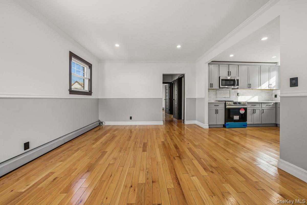 118-27 201st Street Queens, NY 11412 - Photo 3 of 36 a view of kitchen with cabinets and wooden floor