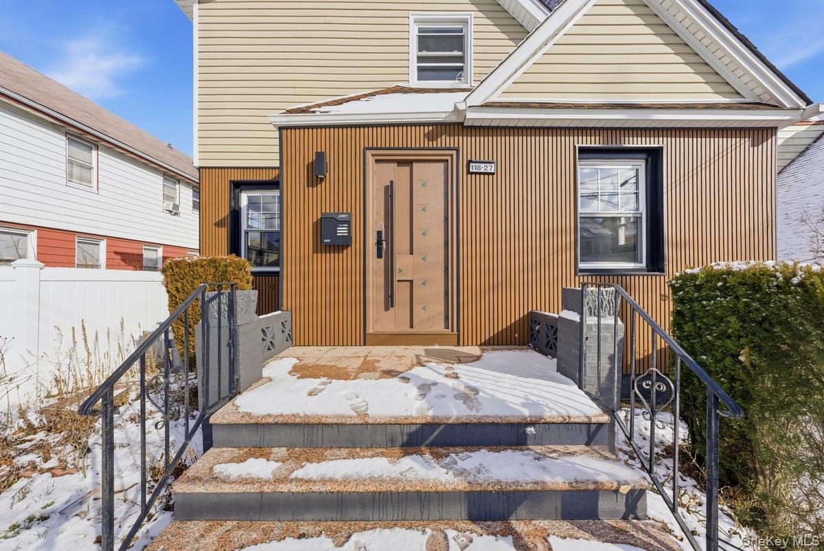 118-27 201st Street Queens, NY 11412 - Photo 32 of 36 a front view of a house with white walls