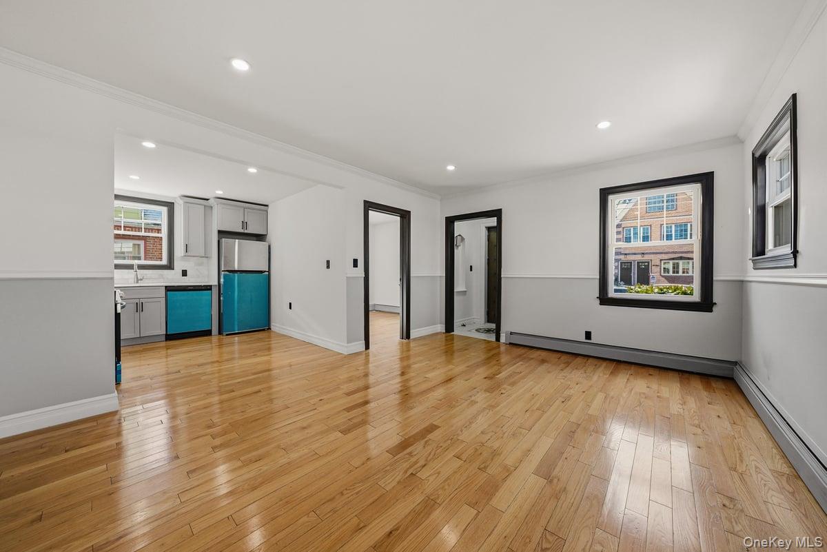 118-27 201st Street Queens, NY 11412 - Photo 4 of 36 a view of empty room with wooden floor and window
