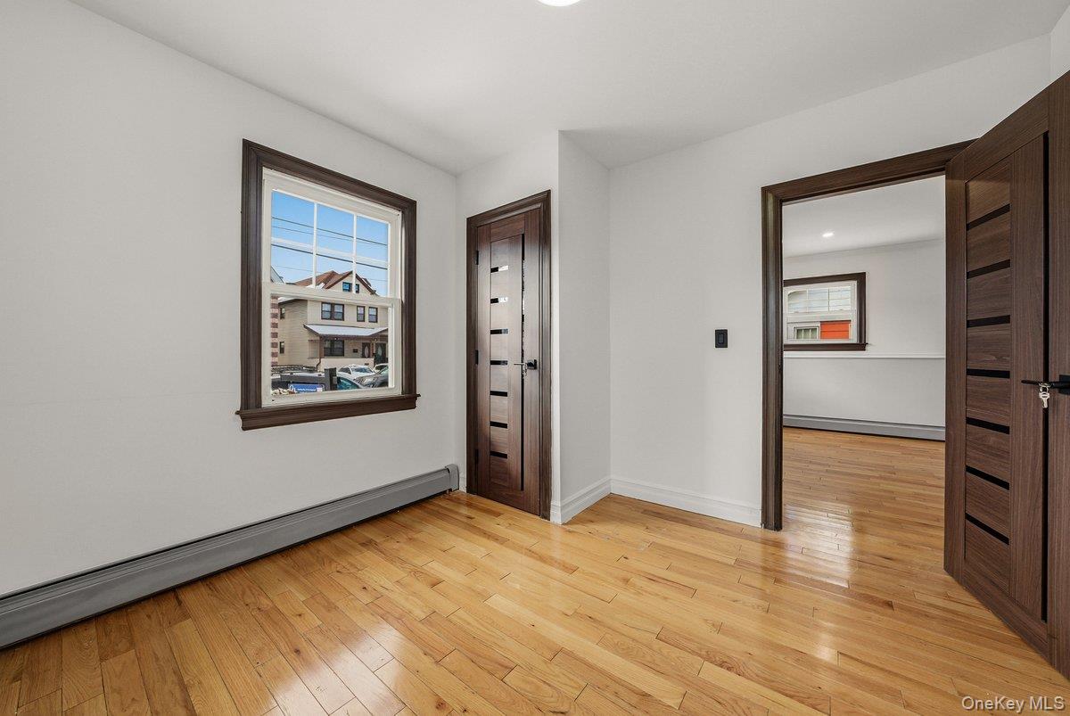 118-27 201st Street Queens, NY 11412 - Photo 6 of 36 a view of an empty room and window