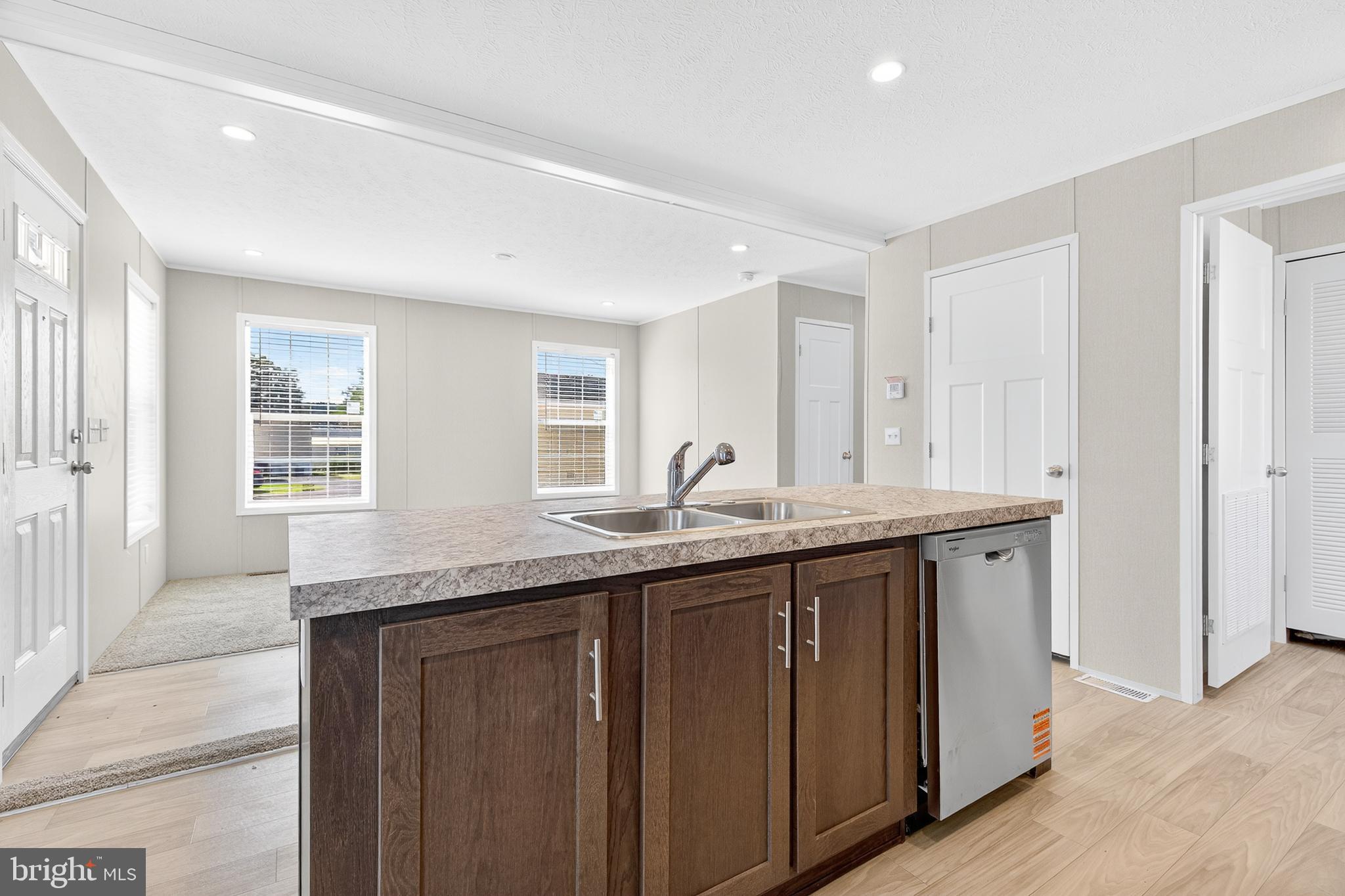 201 Bordic Road Reading, PA 19606 - Photo 20 of 30 a kitchen with granite countertop a sink and dishwasher with wooden cabinets