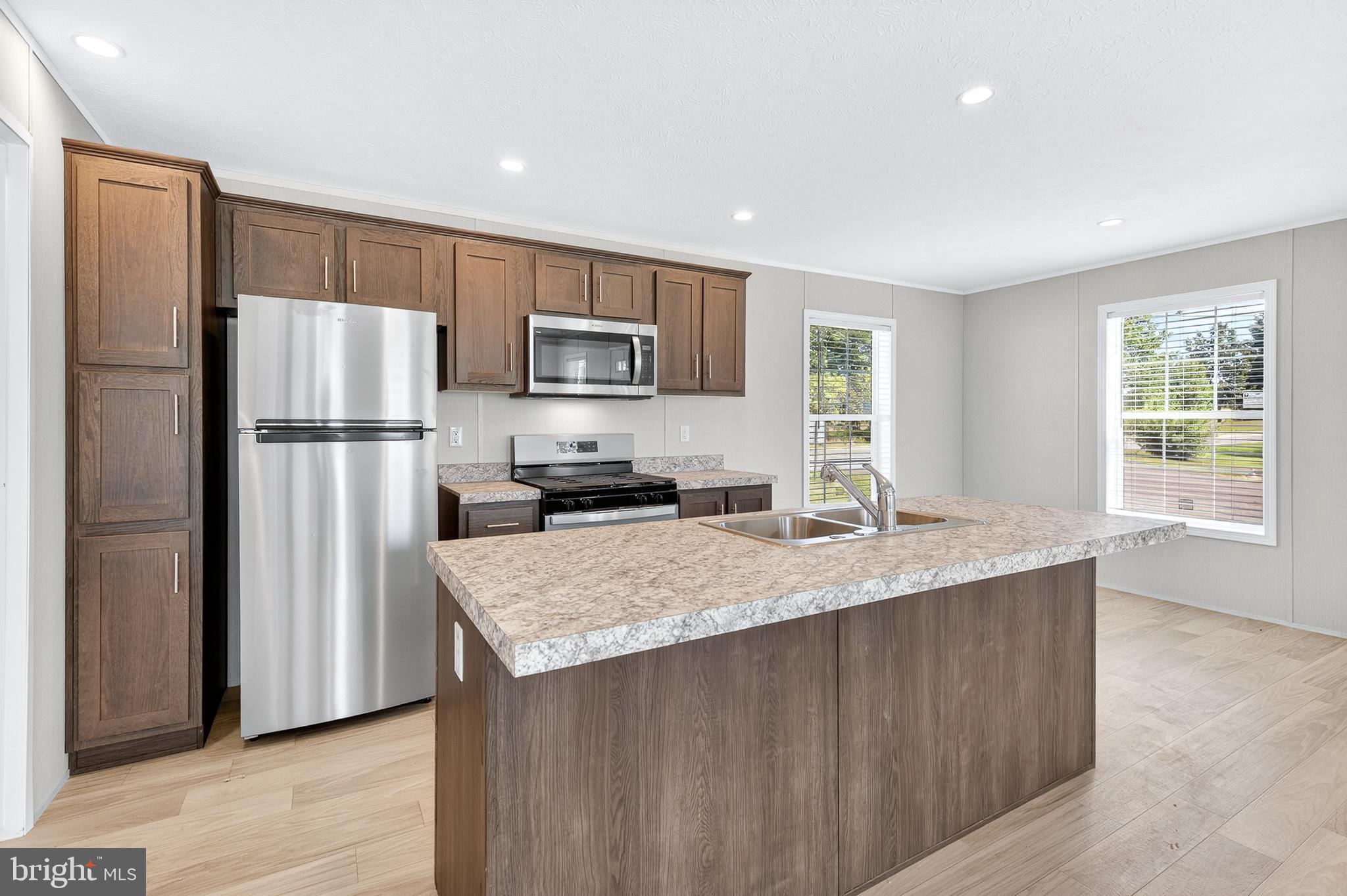 201 Bordic Road Reading, PA 19606 - Photo 22 of 30 a kitchen with kitchen island a refrigerator sink stove and microwave