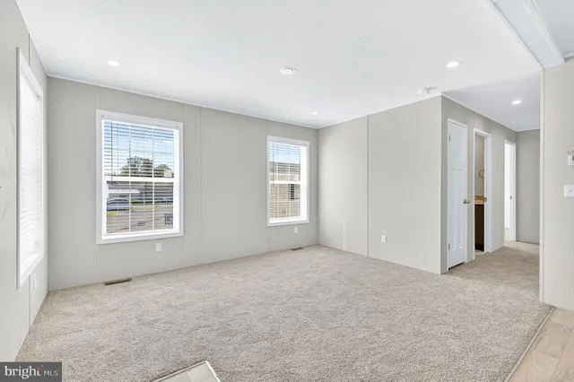a view of a balcony with wooden floor and windows
