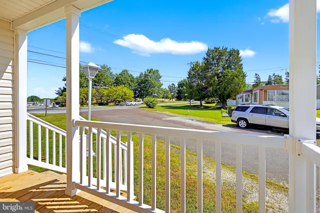 a view of a balcony with wooden floor