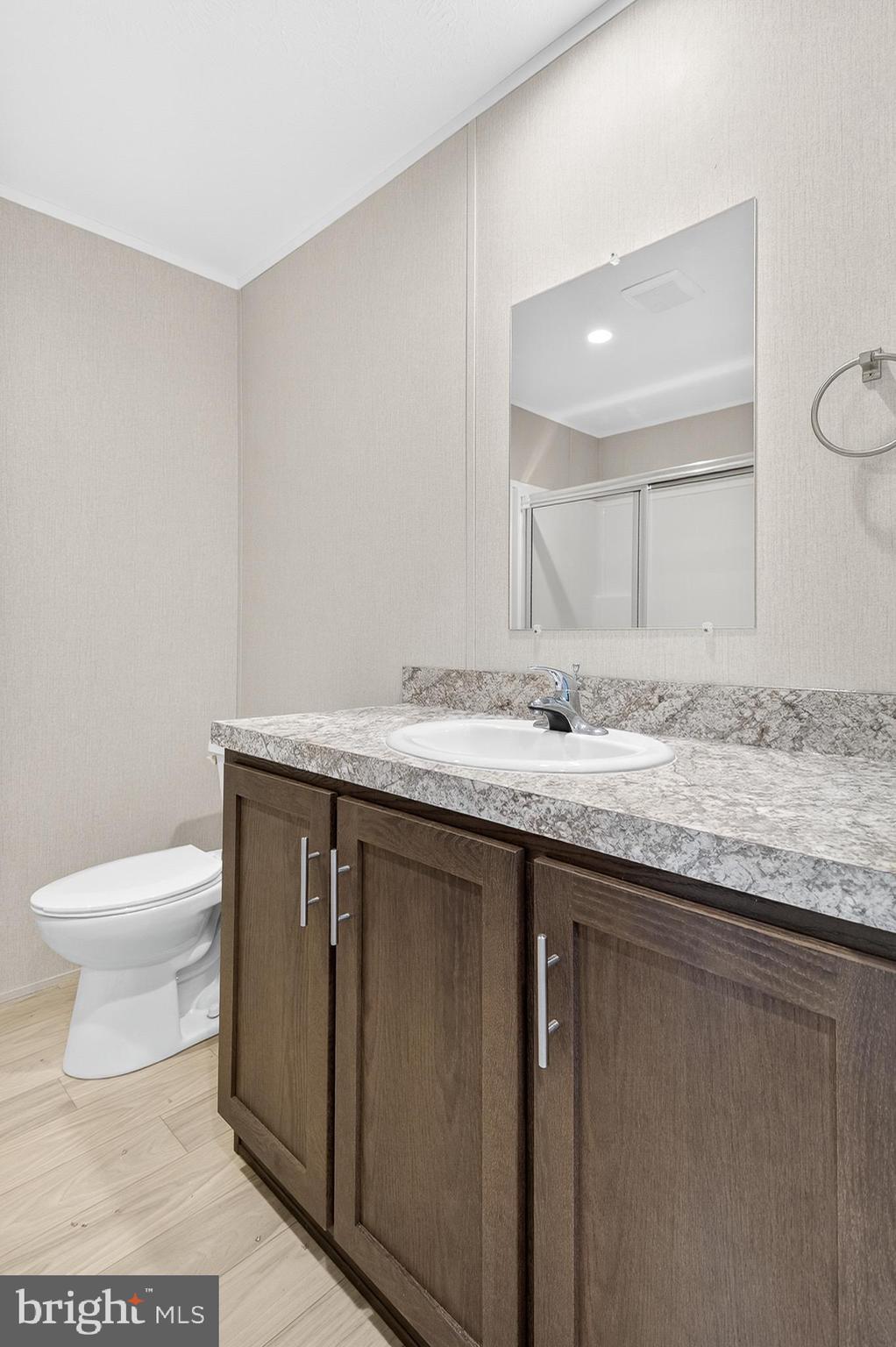 201 Bordic Road Reading, PA 19606 - Photo 8 of 30 a bathroom with a granite countertop sink a toilet and a mirror