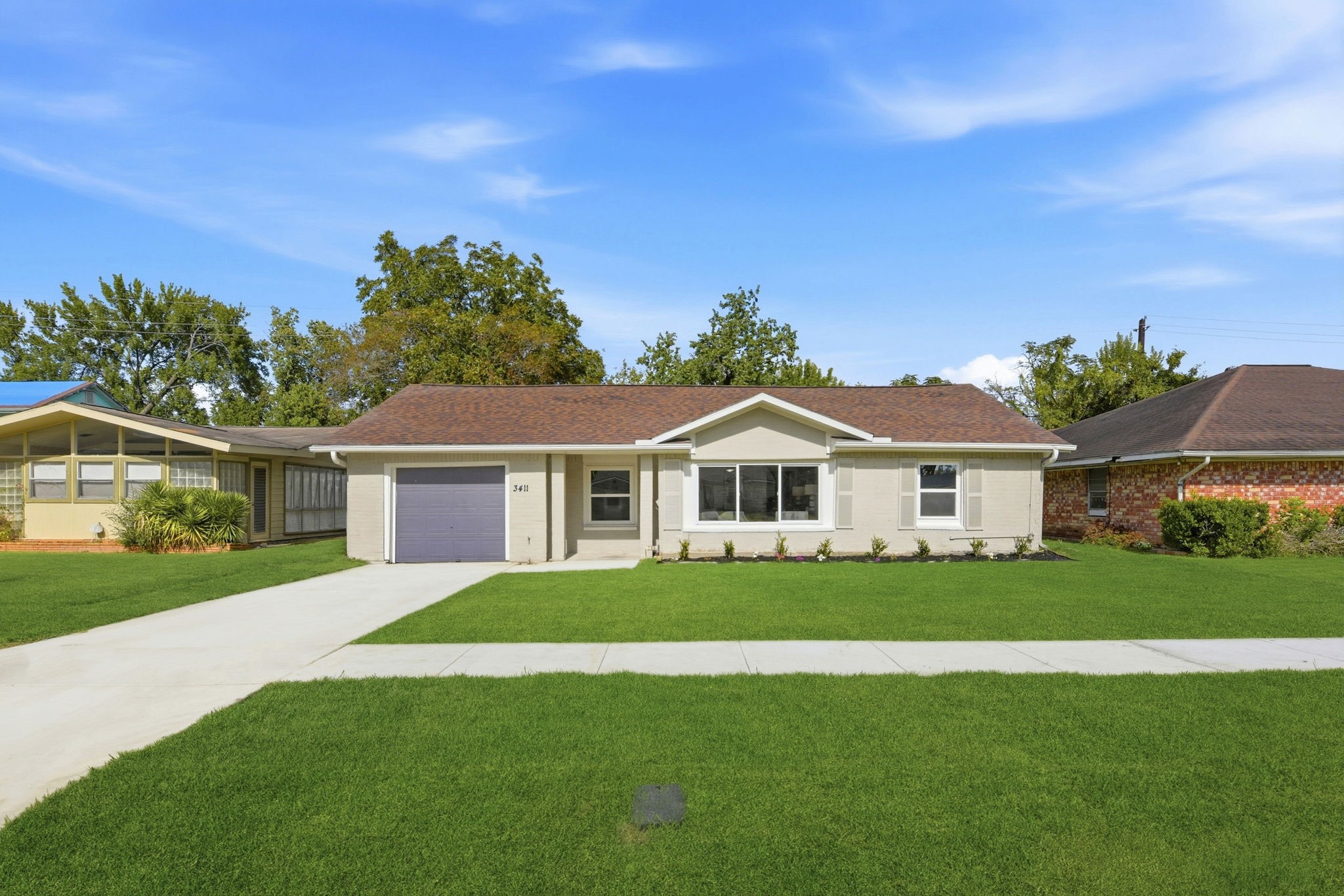 a front view of a house with a garden