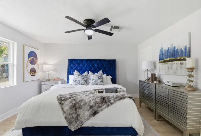 a bedroom with a bed and a painting on the wall