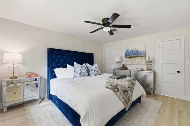 a bedroom with a bed and a chandelier