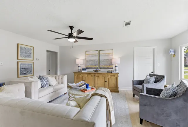 a living room with furniture and a large window