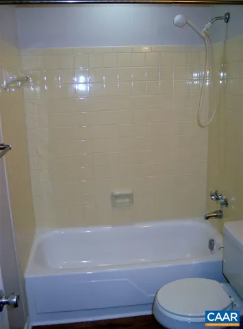 a bathroom with a bathtub and shower