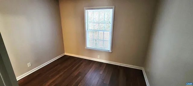 a view of walk in closet with wooden floor