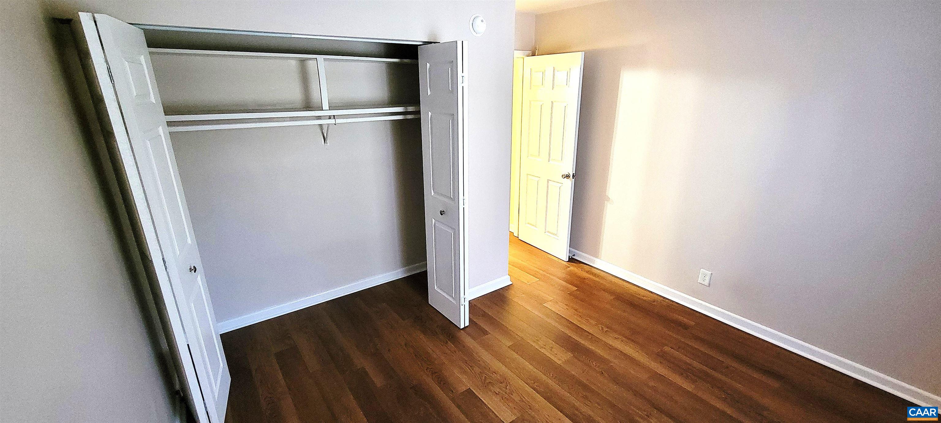 2527 Hydraulic Road, Unit 1 Charlottesville, VA 22901 - Photo 14 of 22 a view of walk in closet with wooden floor