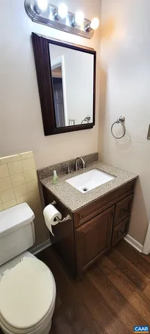 a view of a room with wooden floor