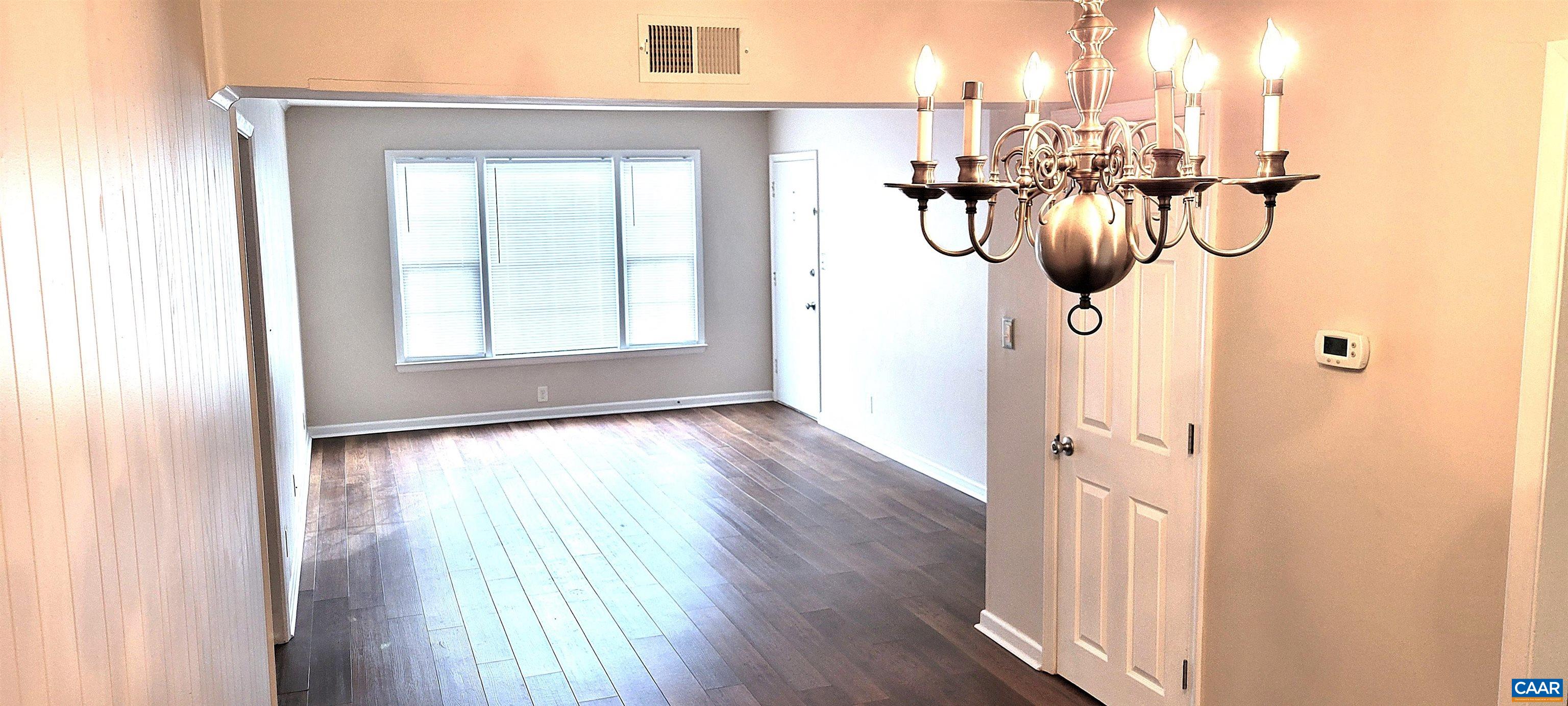 2527 Hydraulic Road, Unit 1 Charlottesville, VA 22901 - Photo 2 of 22 a view of a room with wooden floor mirror and windows