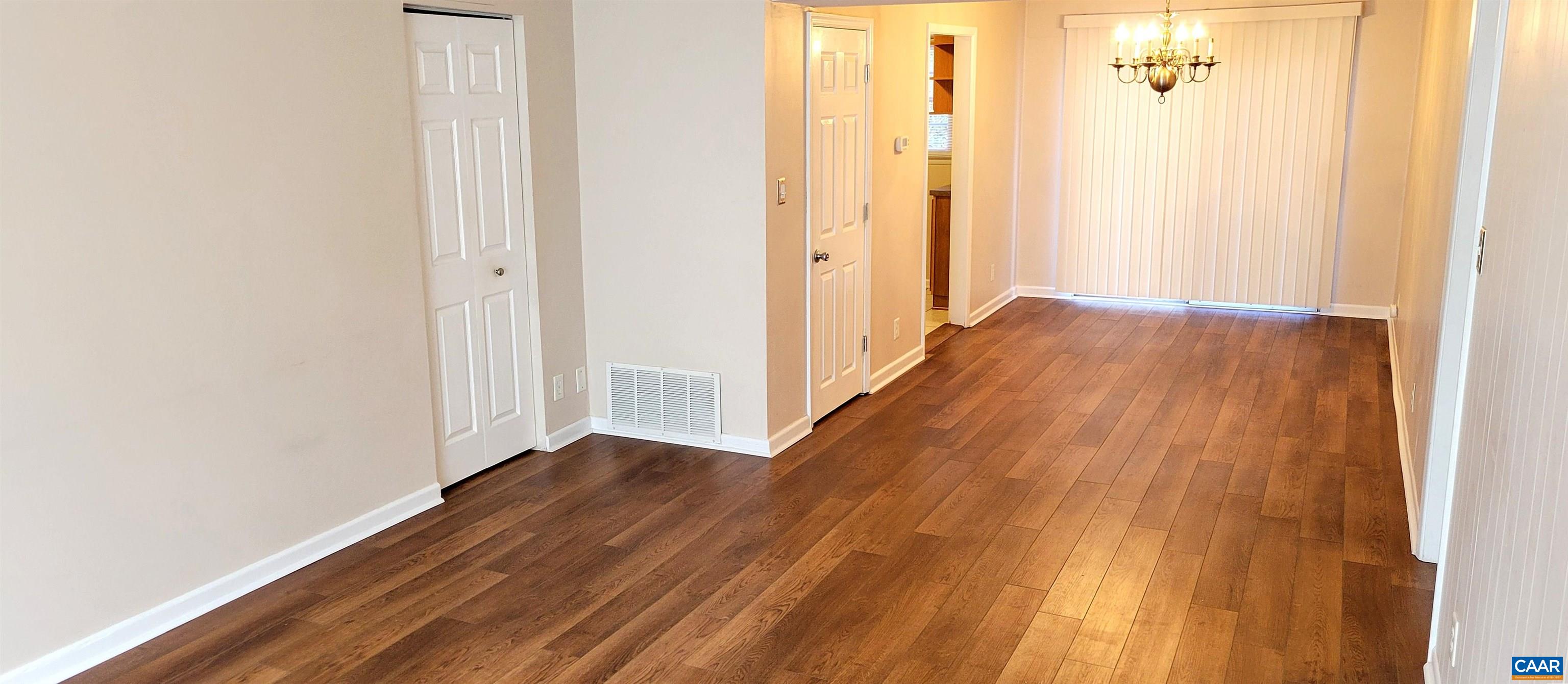 2527 Hydraulic Road, Unit 1 Charlottesville, VA 22901 - Photo 3 of 22 a view of a hallway with wooden floor