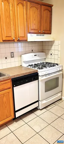 a kitchen with granite countertop cabinets stainless steel appliances and a sink