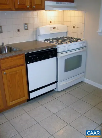 a stove top oven sitting inside of a kitchen