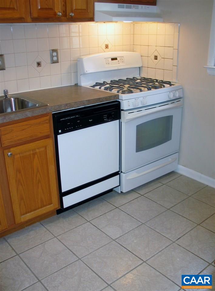 2527 Hydraulic Road, Unit 1 Charlottesville, VA 22901 - Photo 5 of 25 a stove top oven sitting inside of a kitchen