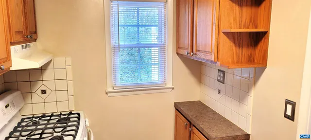 a bathroom with a window and a shower