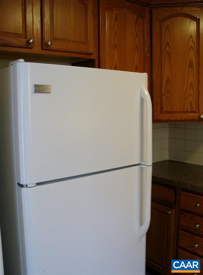 2527 Hydraulic Road, Unit 1 Charlottesville, VA 22901 - Photo 8 of 25 a white refrigerator freezer sitting in a kitchen