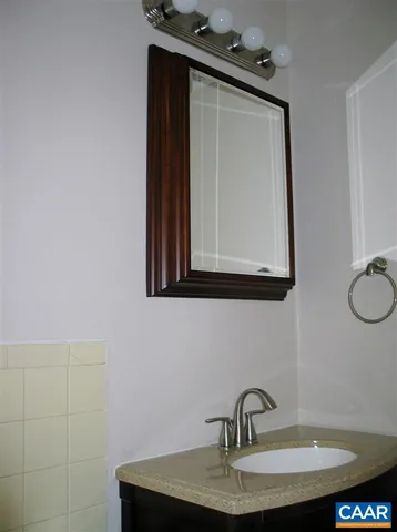 a bathroom with a sink vanity and mirror