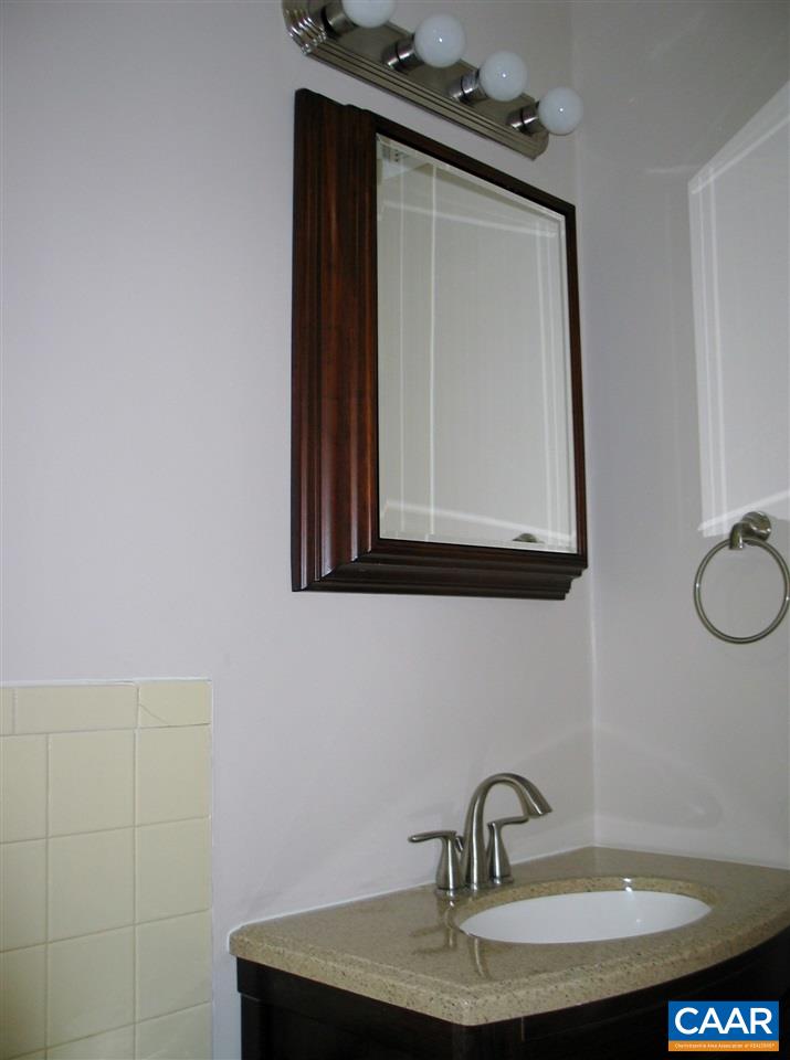 2527 Hydraulic Road, Unit 1 Charlottesville, VA 22901 - Photo 10 of 25 a bathroom with a sink vanity and mirror