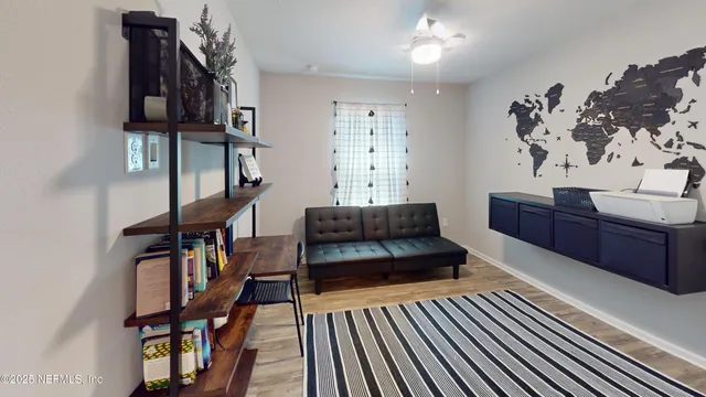 a living room with furniture a piano and a bookshelf