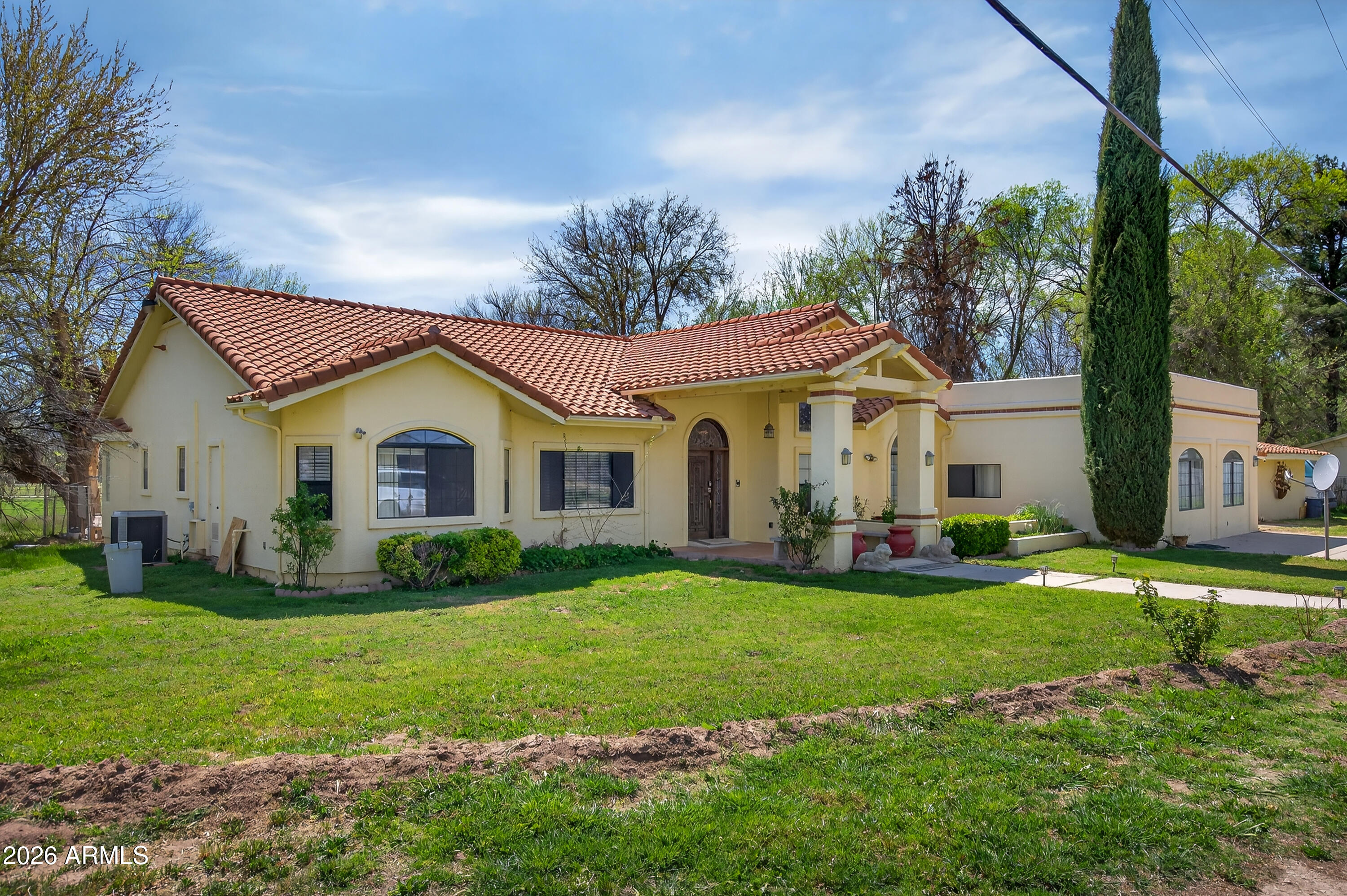 a view of a house with a yard and sitting area