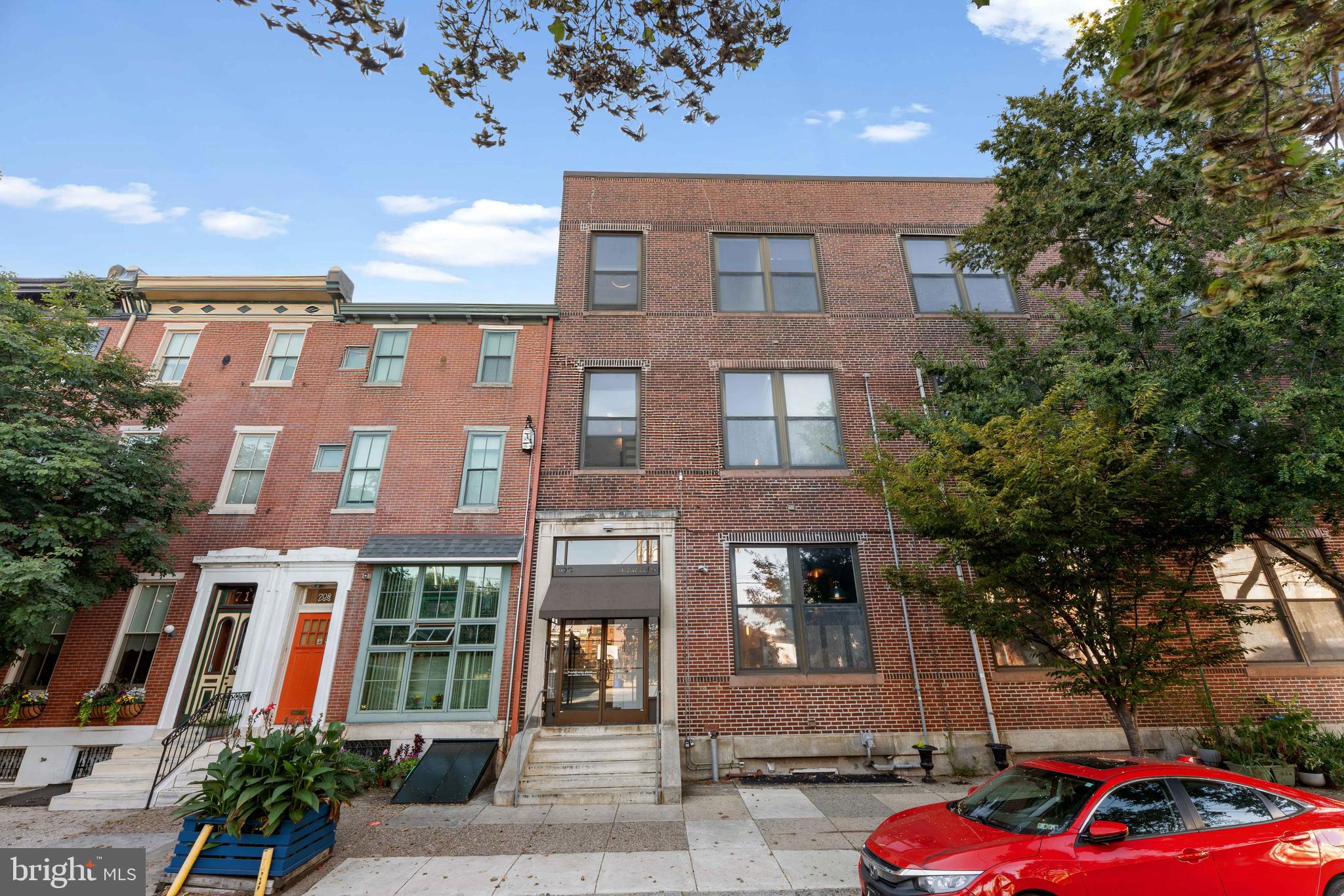 700 South 10th Street, Unit 2F Philadelphia, PA 19147 - Photo 2 of 40 a front view of a residential apartment building with a yard