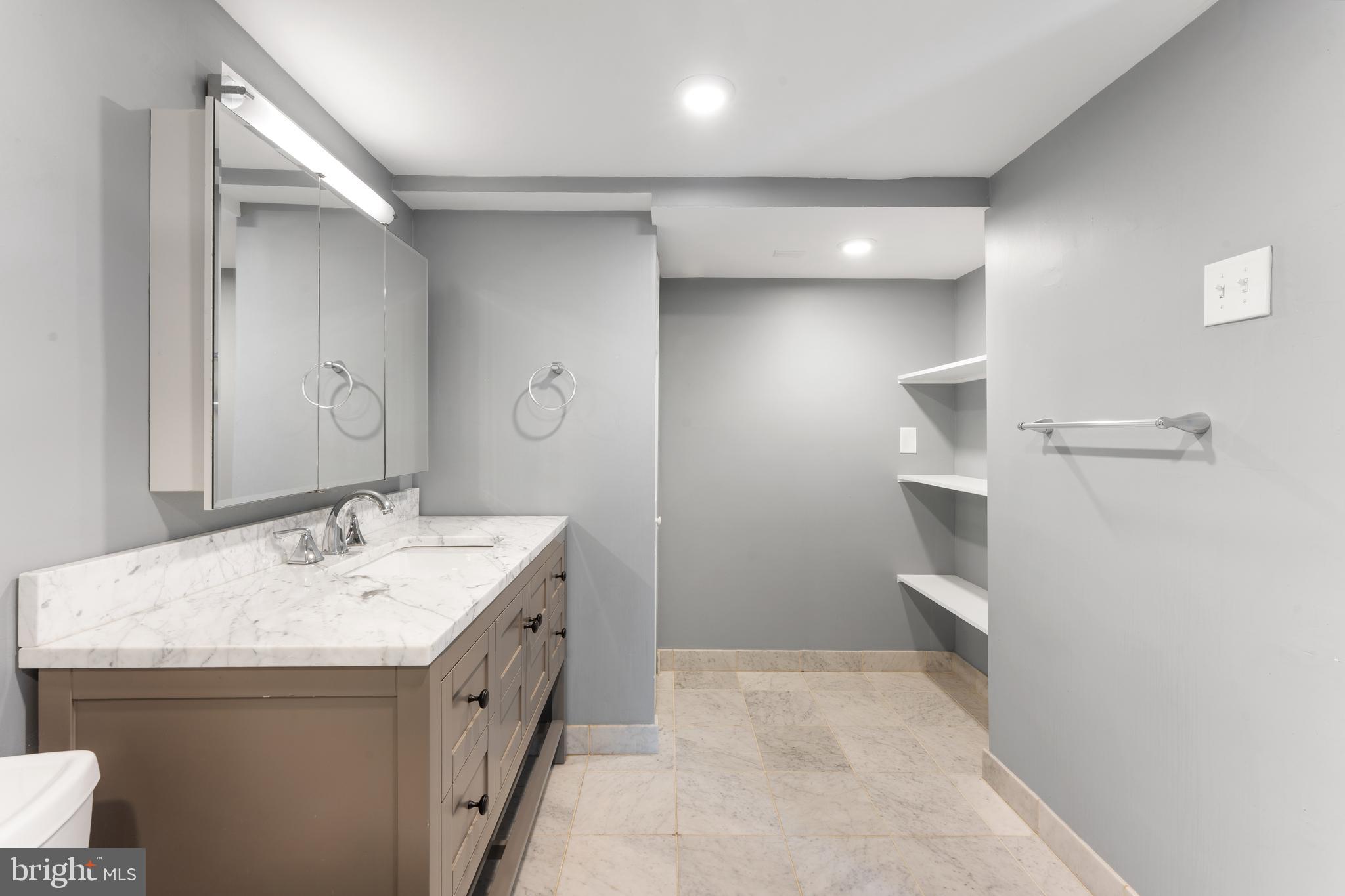 700 South 10th Street, Unit 2F Philadelphia, PA 19147 - Photo 25 of 40 a bathroom with a sink a toilet and a mirror