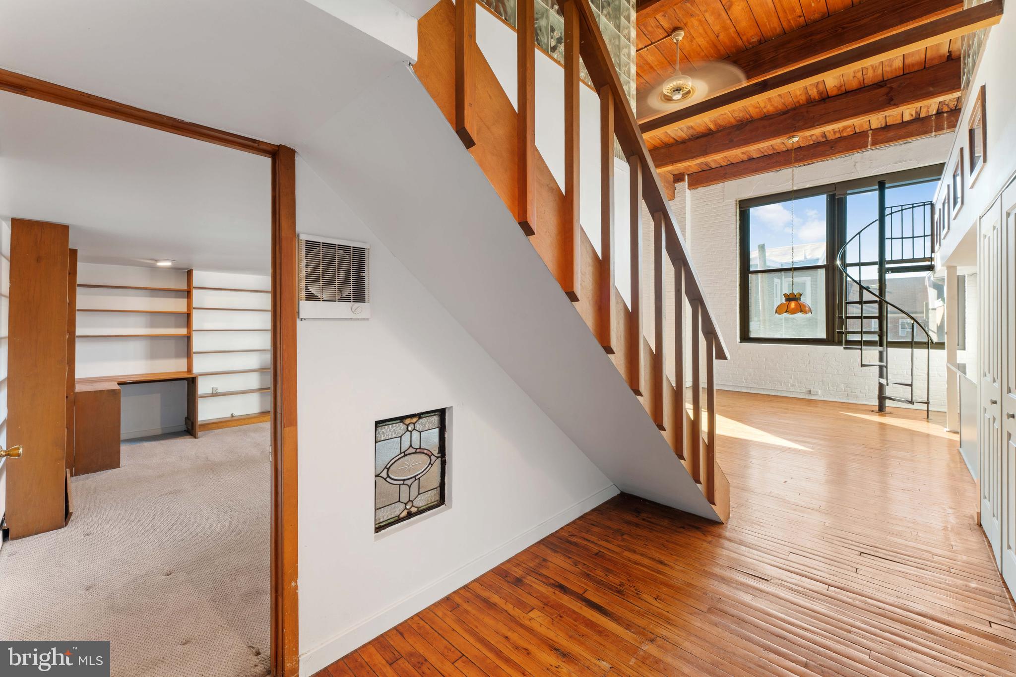 700 South 10th Street, Unit 2F Philadelphia, PA 19147 - Photo 5 of 40 a view of an entryway with wooden floor leading to a furnished livingroom and windows