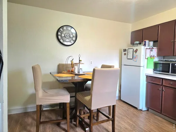 a view of a dining room with furniture a kitchen and chandelier
