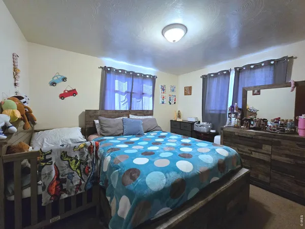 a bedroom with bed and window