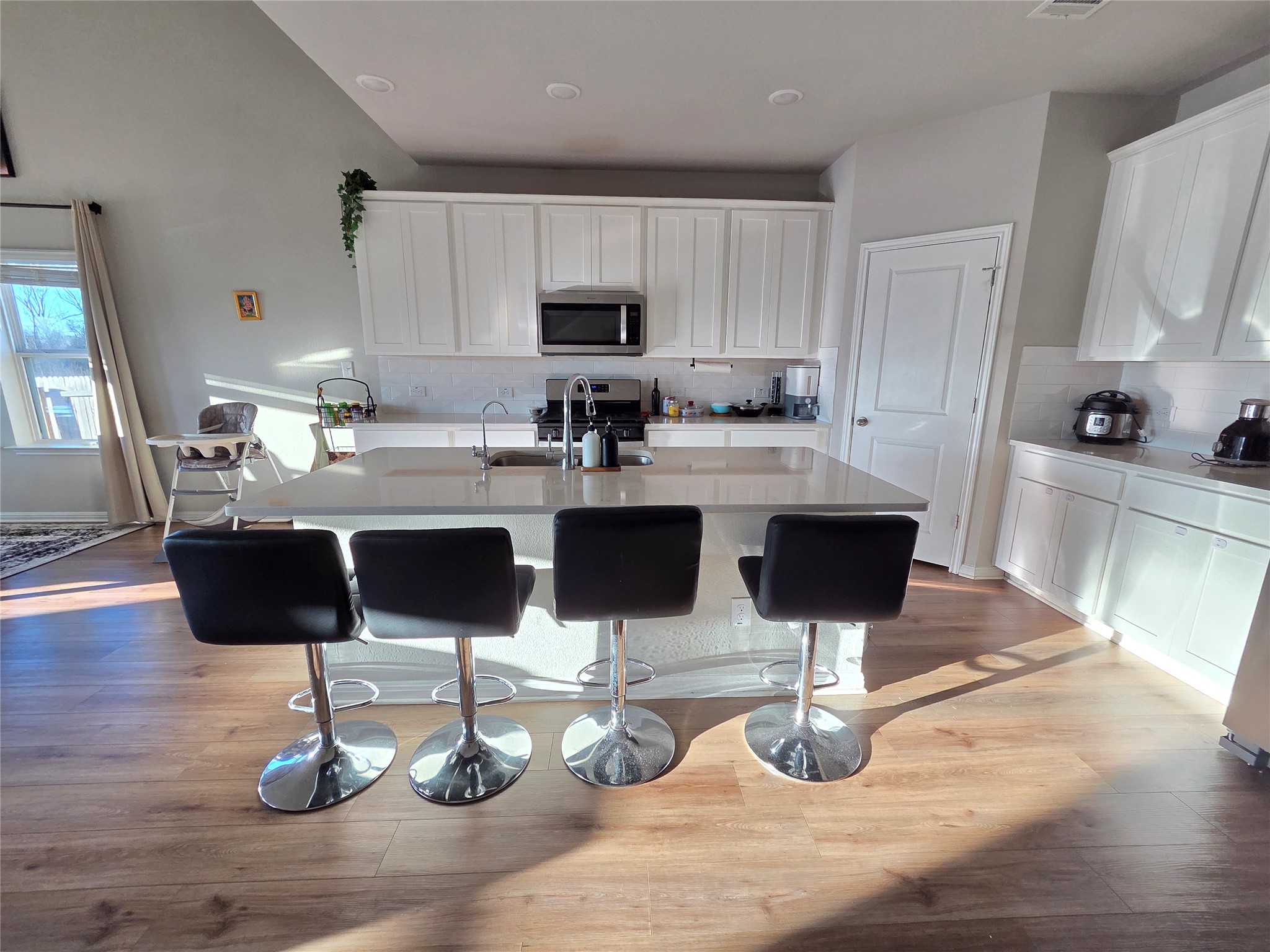 300 Windy Reed Road Hutto, TX 78634 - Photo 6 of 24 a kitchen with stainless steel appliances kitchen island granite countertop a cabinets and wooden floor