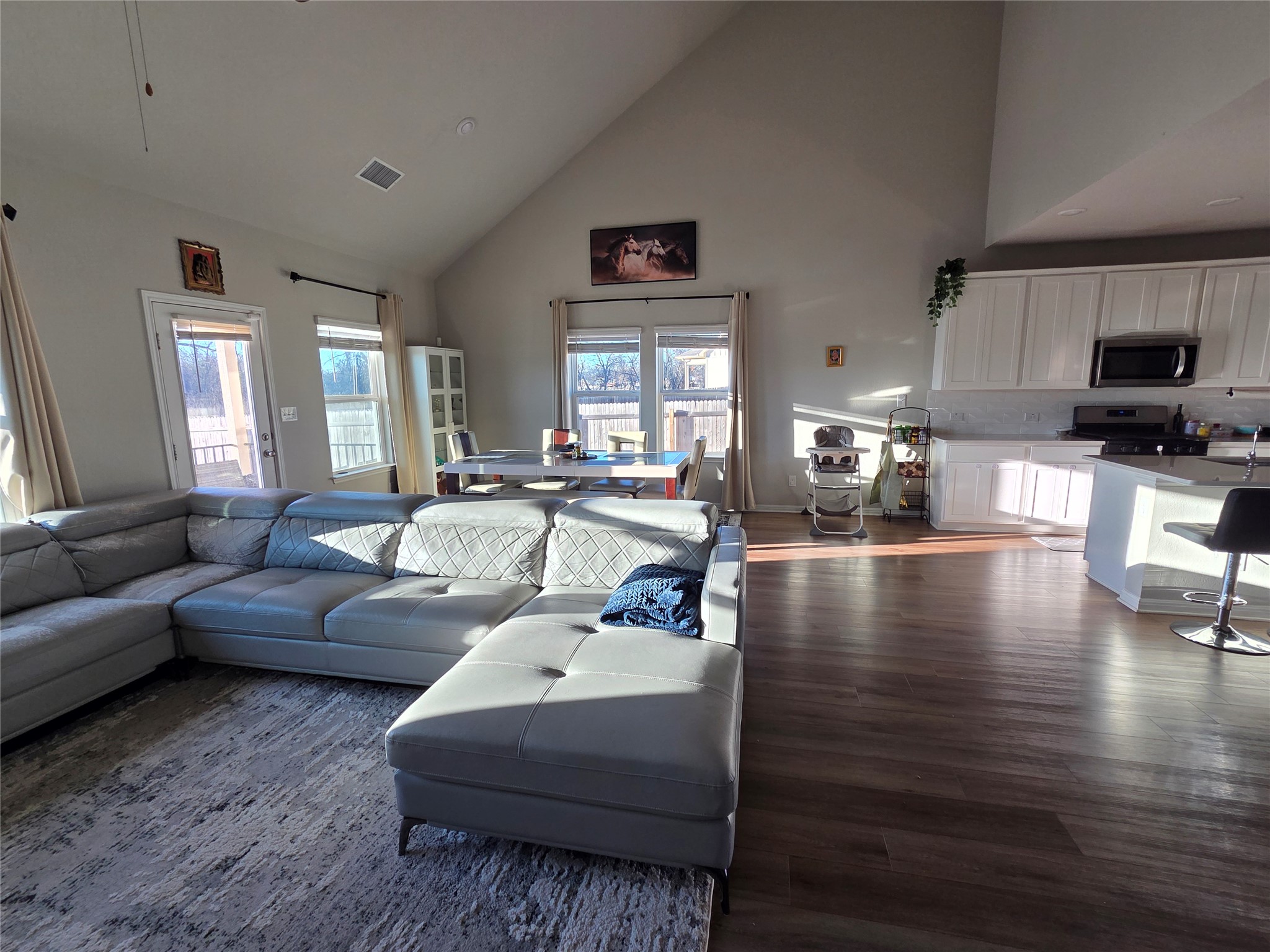 300 Windy Reed Road Hutto, TX 78634 - Photo 8 of 24 a living room with furniture wooden floor and a kitchen