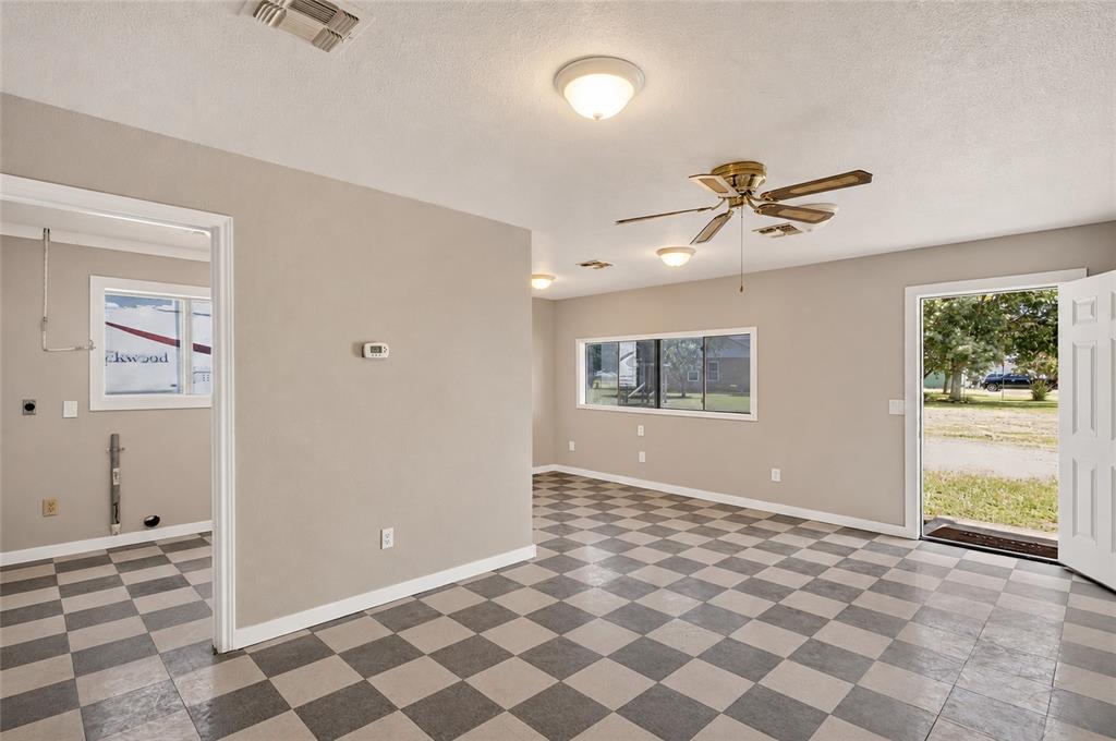 1612 Whitemound Road Sherman, TX 75090 - Photo 21 of 24 Checkered tile flooring with a neutral wall color, overhead lighting, a ceiling fan, and multiple windows providing natural light