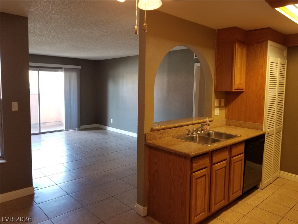1515 East Reno Avenue, Unit A103 Las Vegas, NV 89119 - Photo 10 of 16 This living space flows seamlessly from kitchen to an outdoor area through large glass doors.