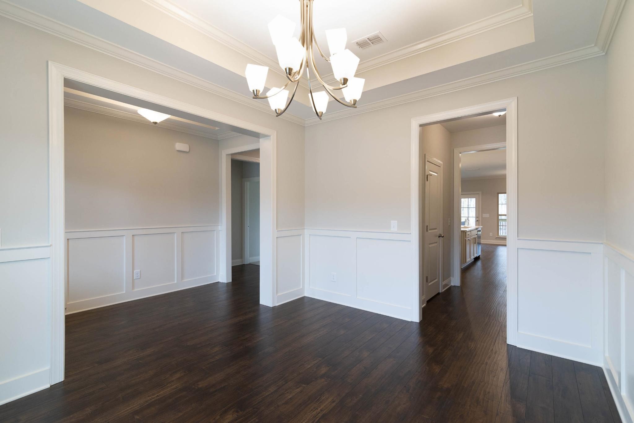 647 Castle Road Mount Juliet, TN 37122 - Photo 2 of 11 a view of a hallway with wooden floor and chandelier