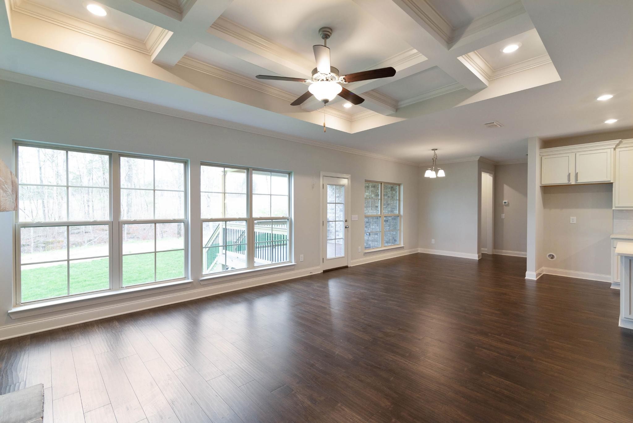 647 Castle Road Mount Juliet, TN 37122 - Photo 3 of 11 an empty room with wooden floor and windows with ceiling fan