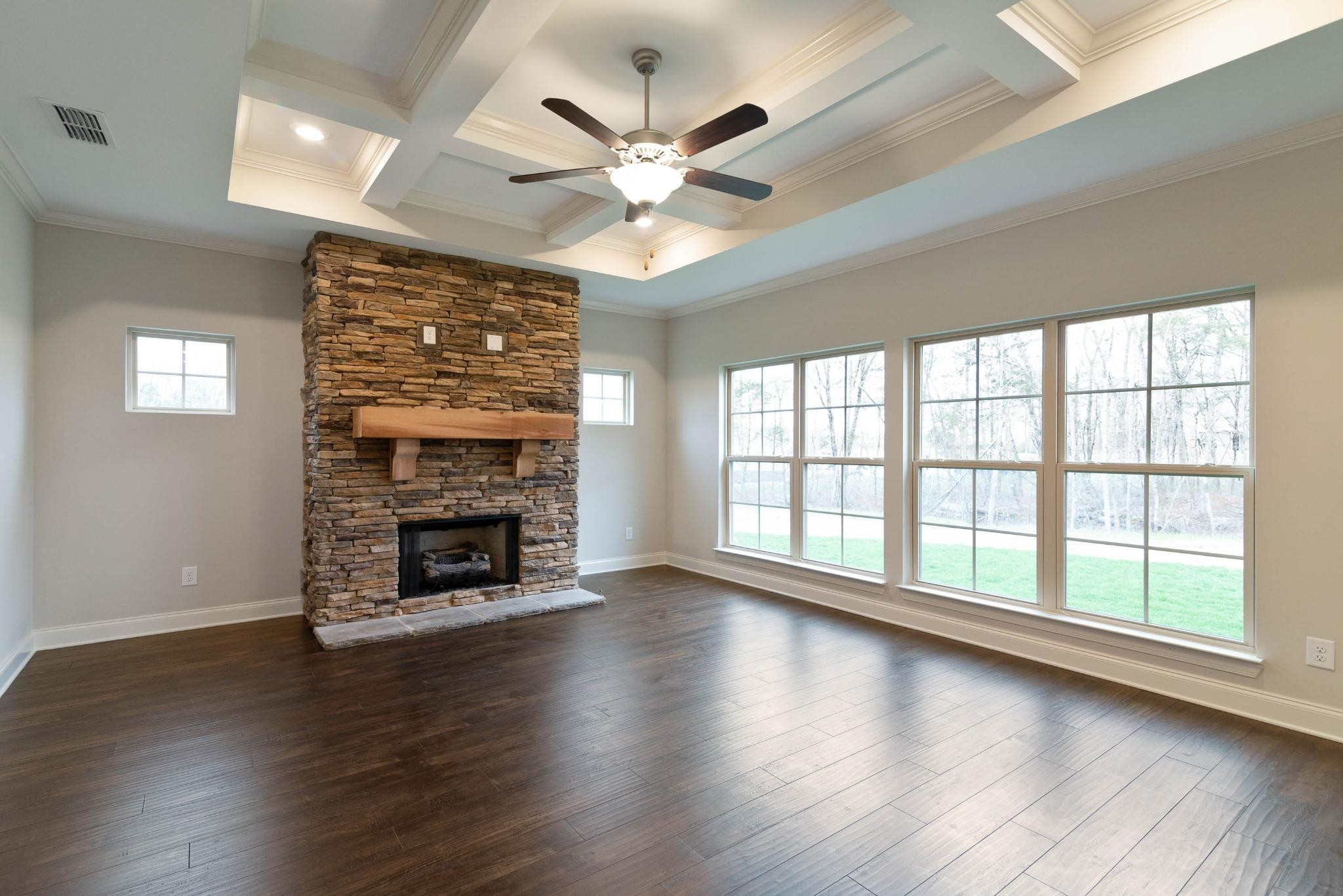 647 Castle Road Mount Juliet, TN 37122 - Photo 4 of 11 a view of an empty room with wooden floor fireplace and a window