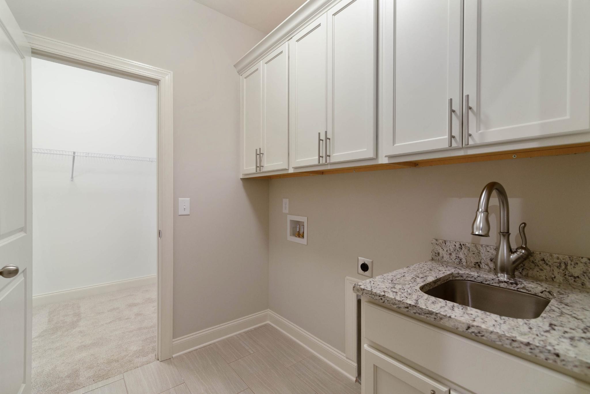 647 Castle Road Mount Juliet, TN 37122 - Photo 10 of 11 a kitchen with granite countertop white cabinets and a sink