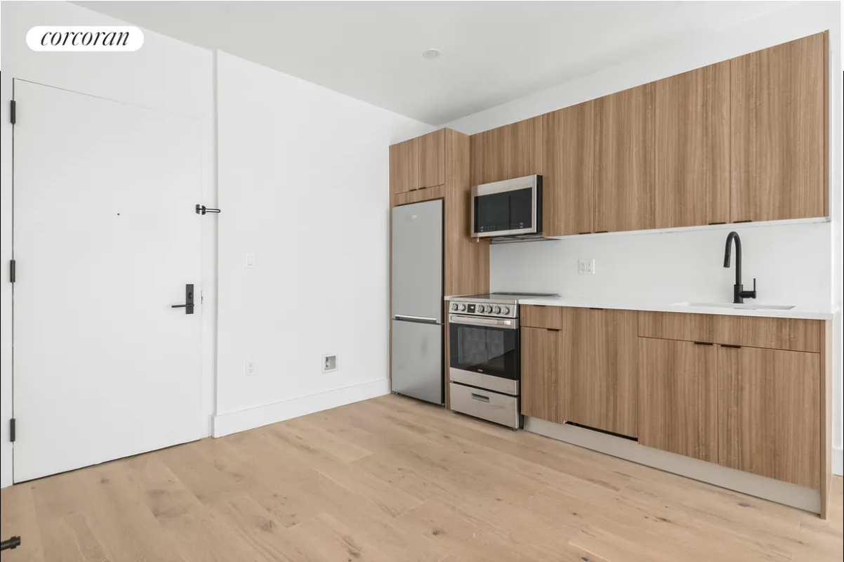 a kitchen with stainless steel appliances a refrigerator and a microwave