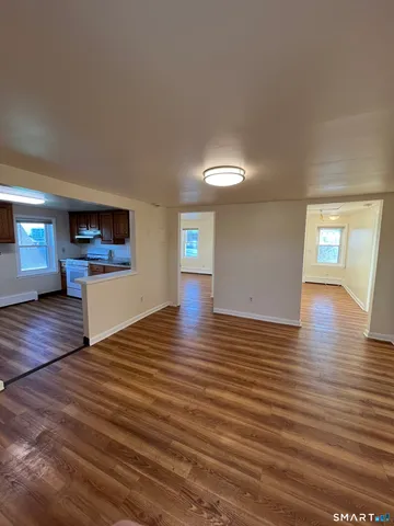 a view of a room with wooden floor and window