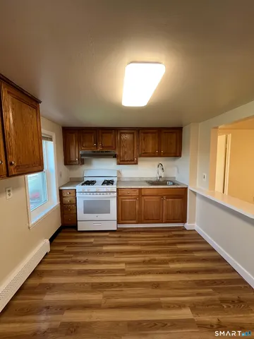 a kitchen with stainless steel appliances a stove sink and cabinets