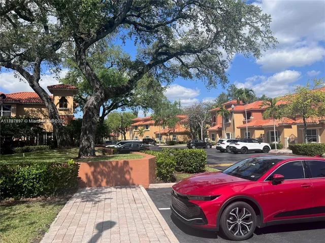 a front view of a house with a garden and tree